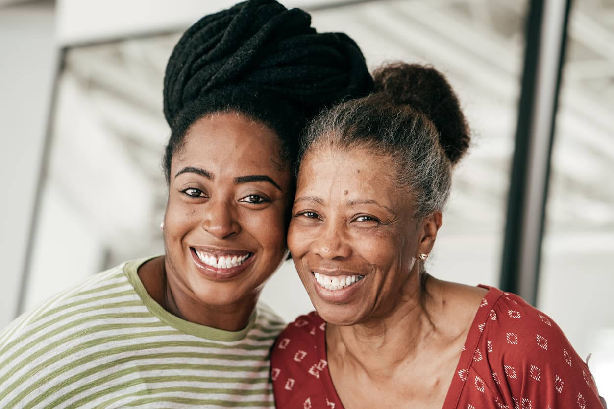 A mother and daughter smiling together